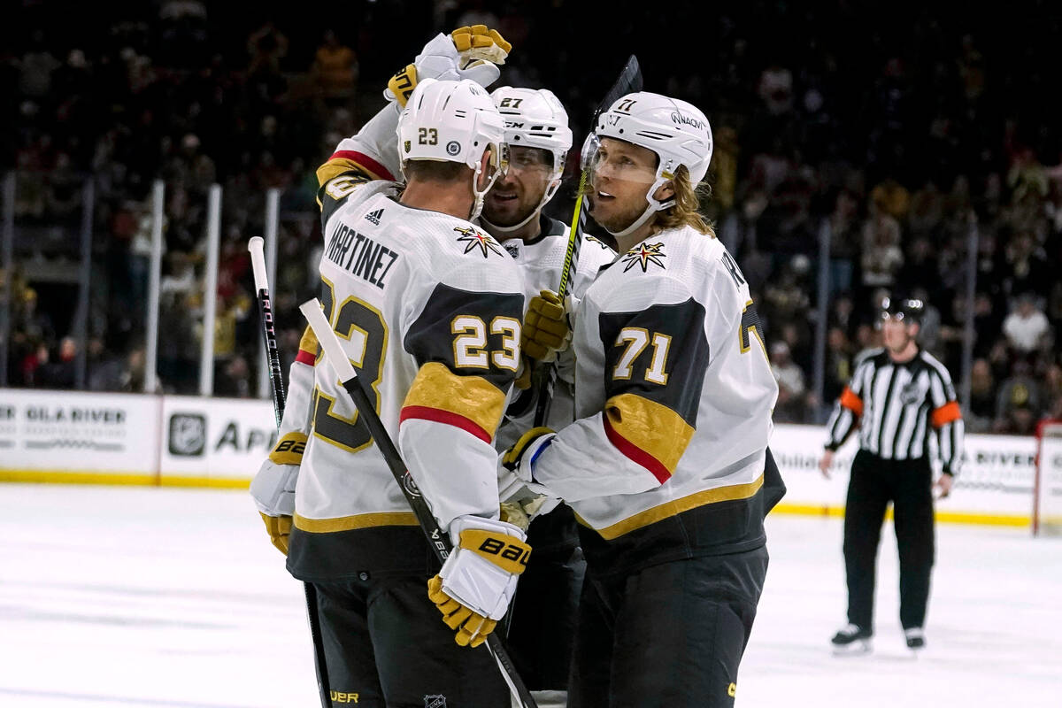 Vegas Golden Knights' Alec Martinez (23) andShea Theodore, middle, celebrate William Karlsson's ...