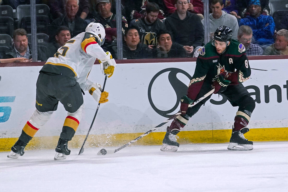 Arizona Coyotes center Nick Schmaltz (8) controls the puck in front of Vegas Golden Knights def ...