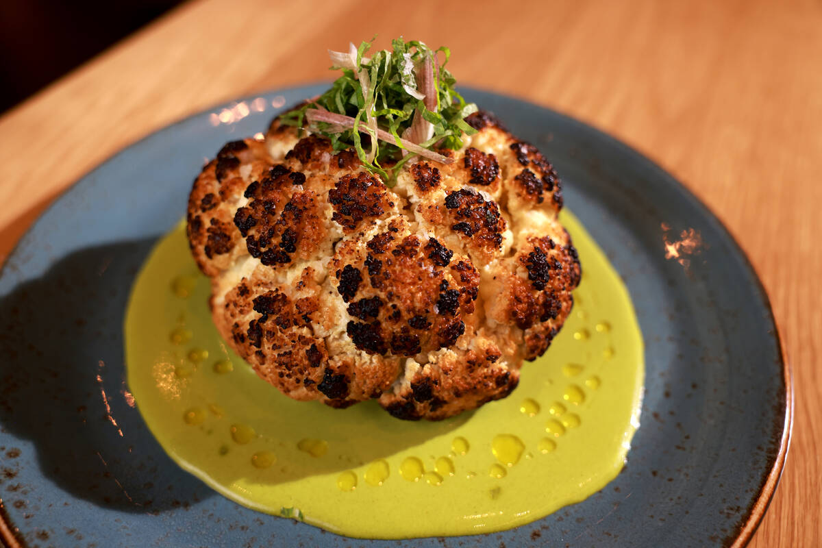 Roasted cauliflower with whipped goat cheese and shishito-herb vinaigrette at KYU, an American ...