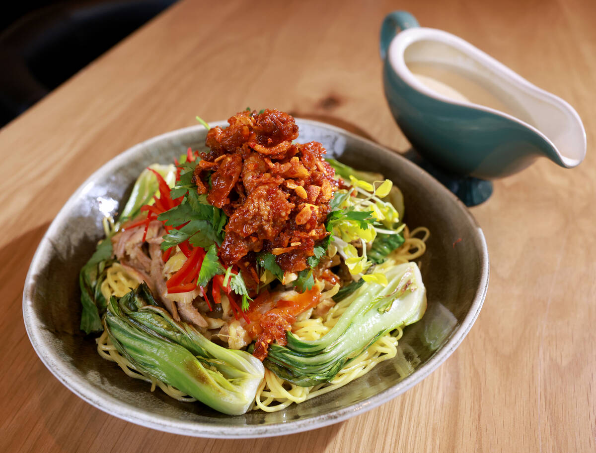 Malaysian–style chicken laksa is the first dish of the two-part Royal Golden Chicken at KYU, ...