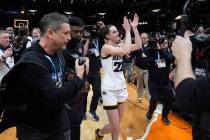 Iowa guard Caitlin Clark (22) walks off the court after a Final Four college basketball game ag ...
