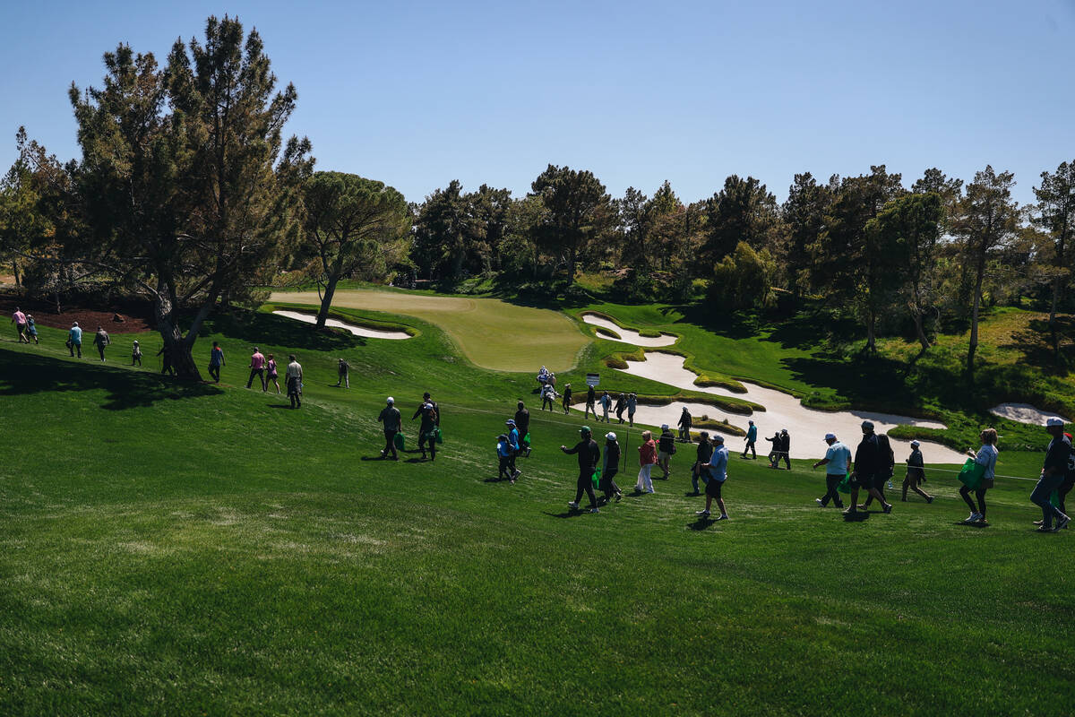 Golf fans walk throughout the course during the T-Mobile Match Play semifinals at Shadow Creek ...