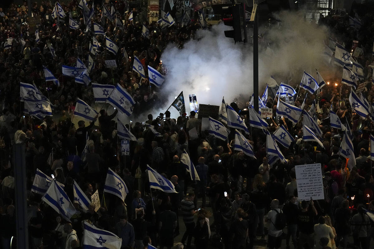 People take part in a protest against Israeli Prime Minister Benjamin Netanyahu's government an ...