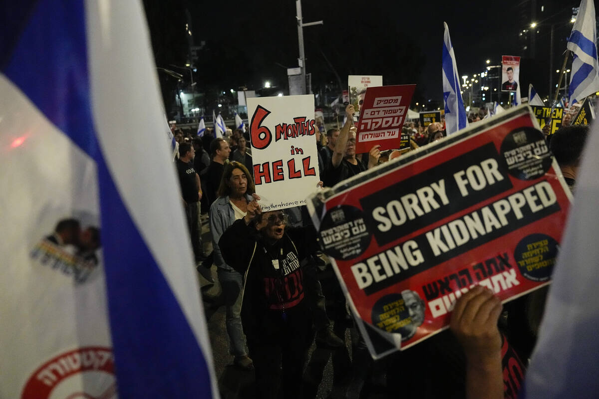 People take part in a protest against Israeli Prime Minister Benjamin Netanyahu's government an ...