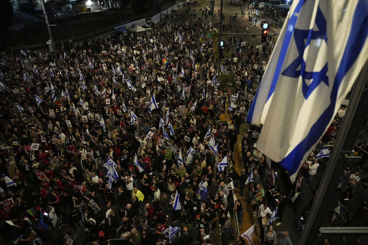 People take part in a protest against Israeli Prime Minister Benjamin Netanyahu's government an ...