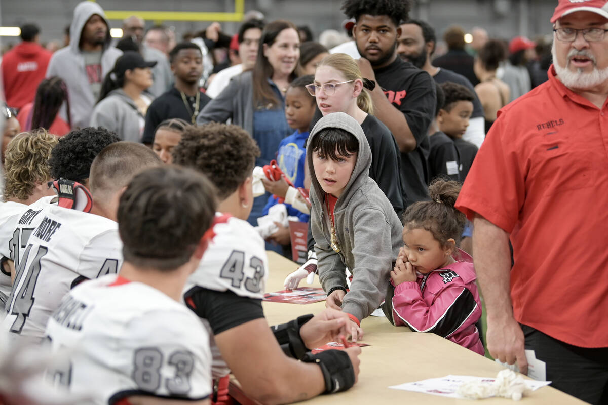 Fans line up for player autographs during UNLV football’s Spring Showcase scrimmage Satu ...
