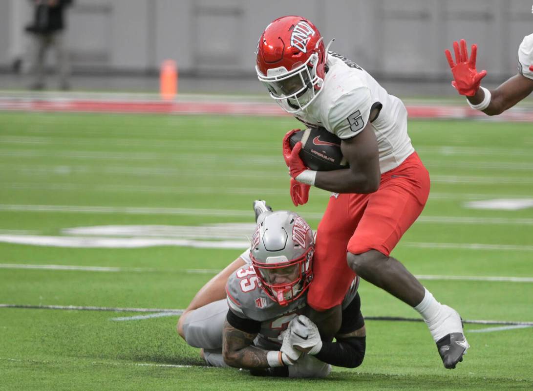UNLV defensive back Anthony Costanzo tackles running back Greg Burrell during UNLV football&#x2 ...