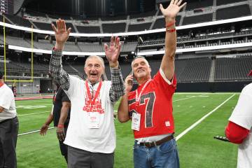 Former UNLV head coach Harvey Hyde and player Ron Drake wave to fans during UNLV football&#x201 ...