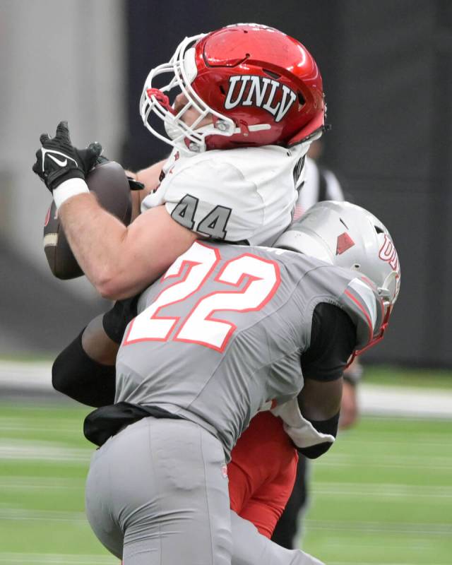 UNLV defensive back Elijah Wilson stops tight end Christian Moore during UNLV football’s ...