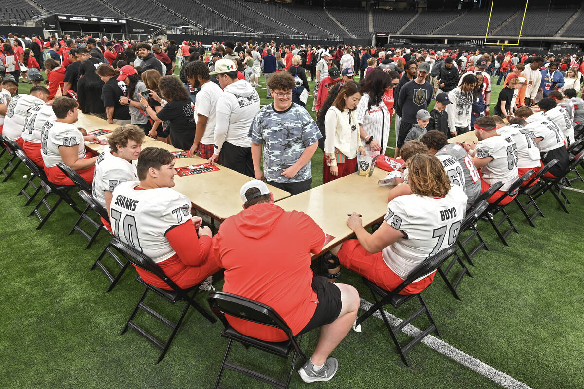 Fans line up for player autographs during UNLV football’s Spring Showcase scrimmage Satu ...
