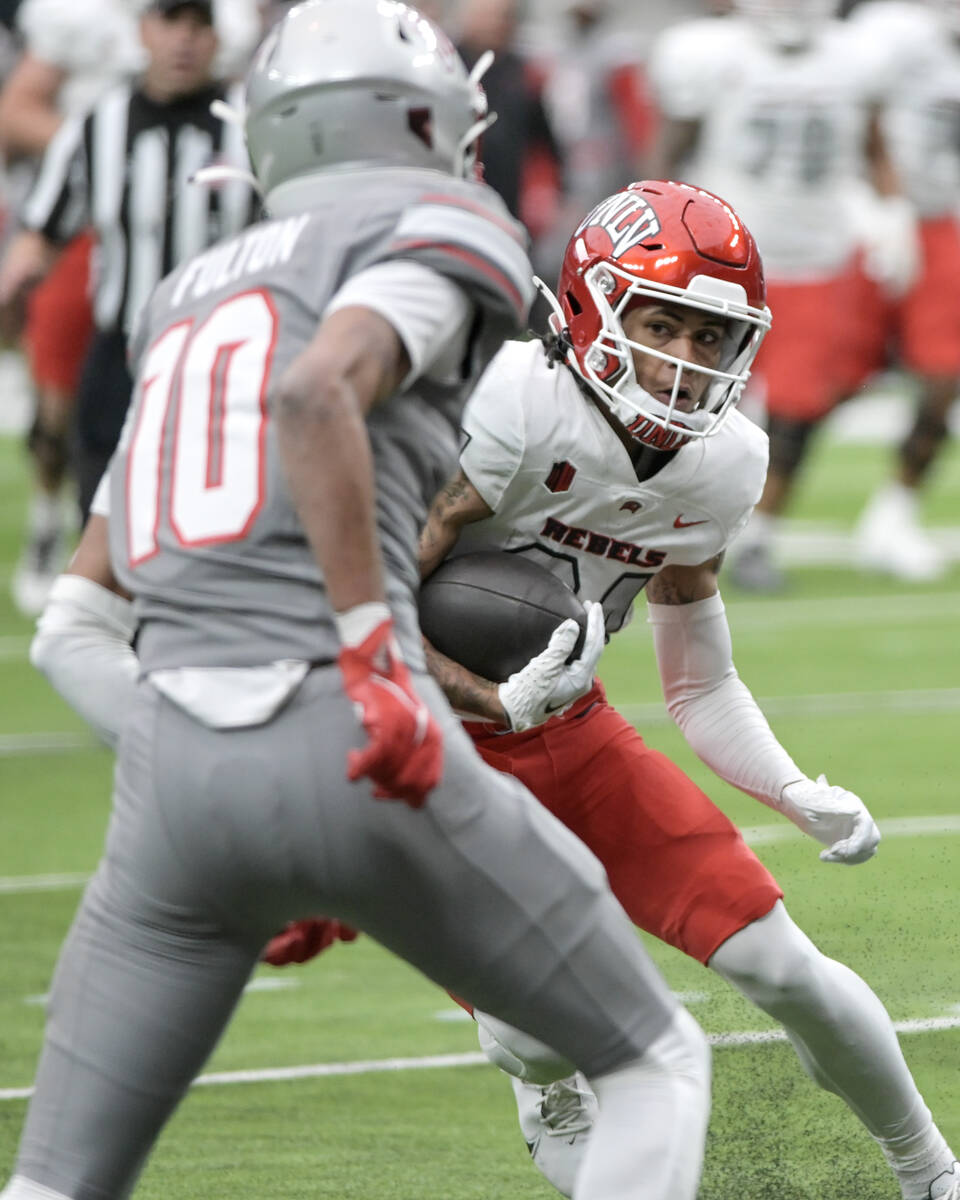 UNLV wide receiver Corey Thompson Jr. looks for a way around defensive back Tre Fulton during U ...