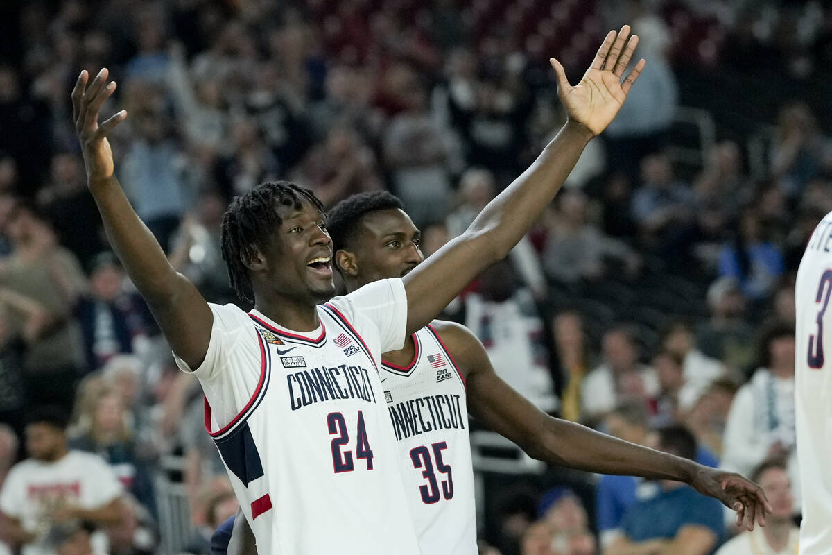 UConn center Youssouf Singare (24) and forward Samson Johnson (35) celebrate after after their ...