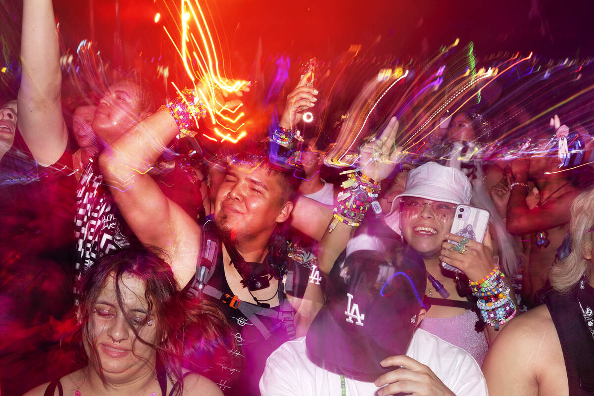 Ravers pump their fists during the second day of electronic dance music festival Electric Daisy ...