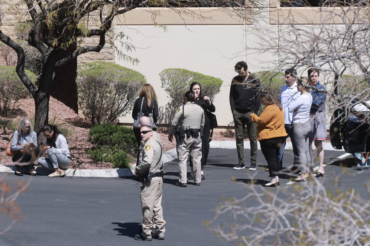 People gather outside a building after a shooting at the Prince Law Group on West Charleston Bo ...
