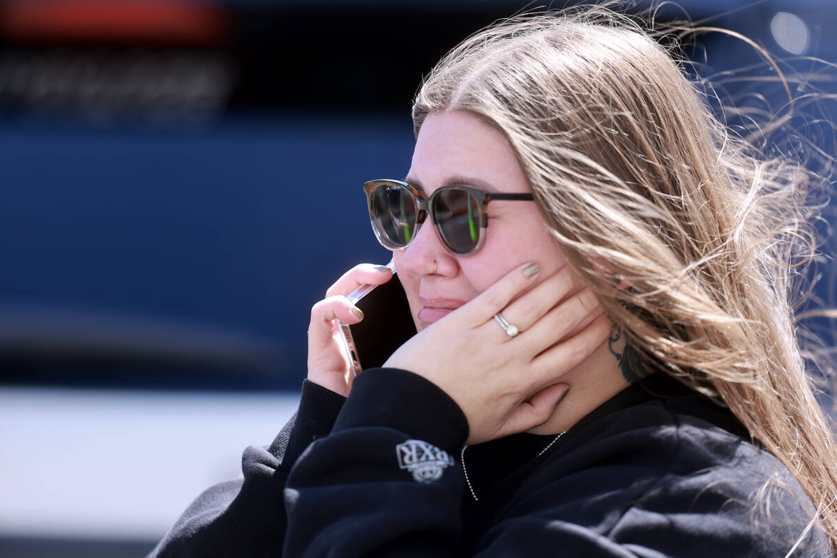 A woman talks on a phone after a shooting at the Prince Law Group on West Charleston Boulevard ...