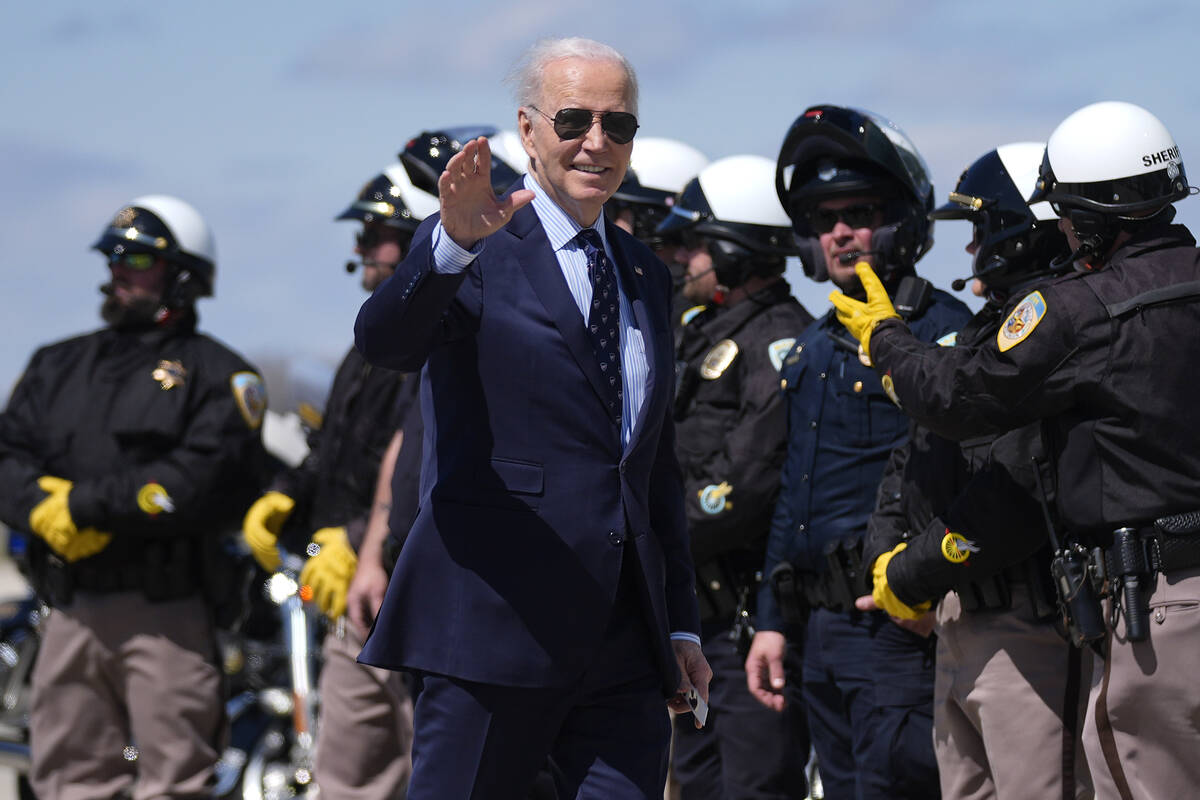 President Joe Biden waves as he walk to Air Force One in Dane County Regional Airport Monday, A ...