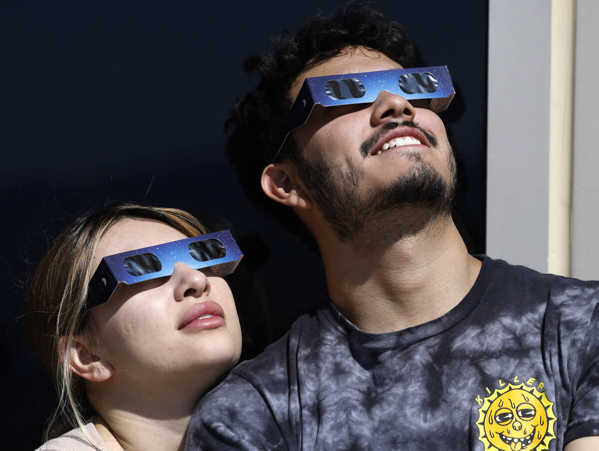 Chris Tejeda and his girlfriend, Valentina Cernas, watch a partial solar eclipse at the observa ...