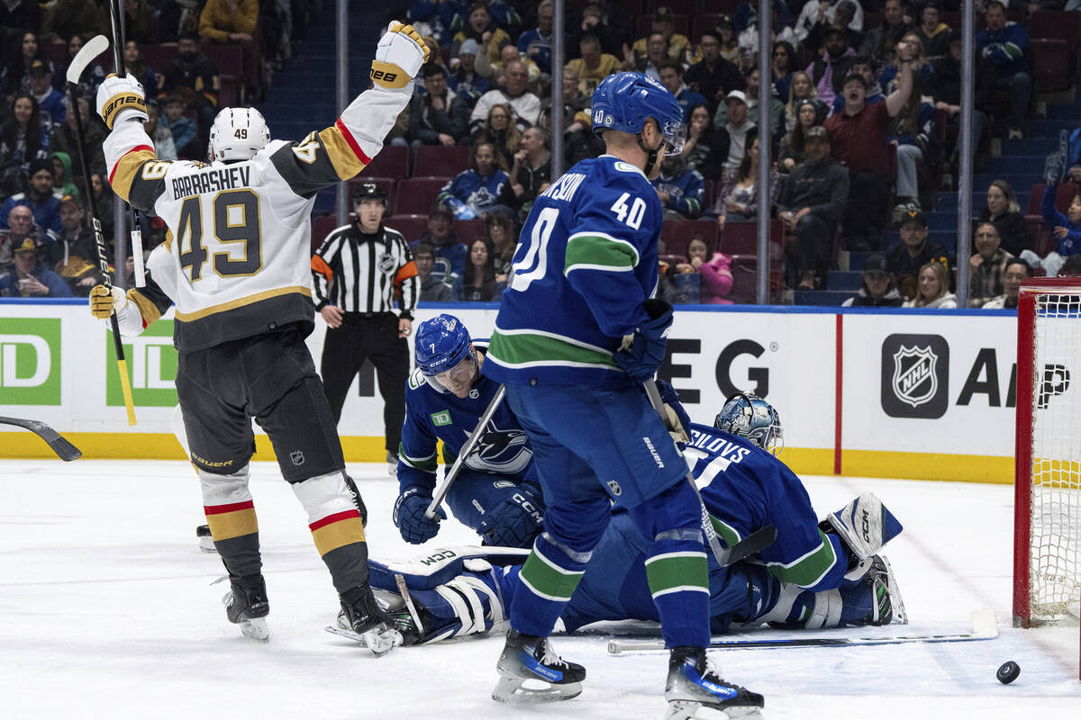 Vegas Golden Knights' Ivan Barbashev (49) celebrates Jack Eichel's goal as Vancouver Canucks' C ...