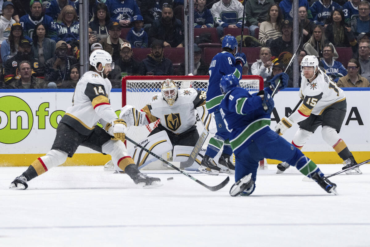 Vancouver Canucks' J.T. Miller (9) shoots the puck as Vegas Golden Knights goaltender Logan Tho ...