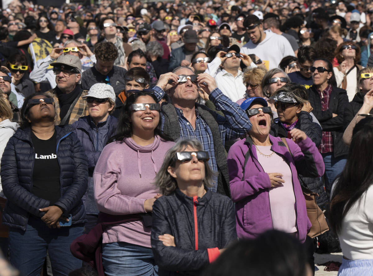 People watch the total solar eclipse at Parc Jean Drapeau, in Montreal, Monday, April 8, 2024. ...