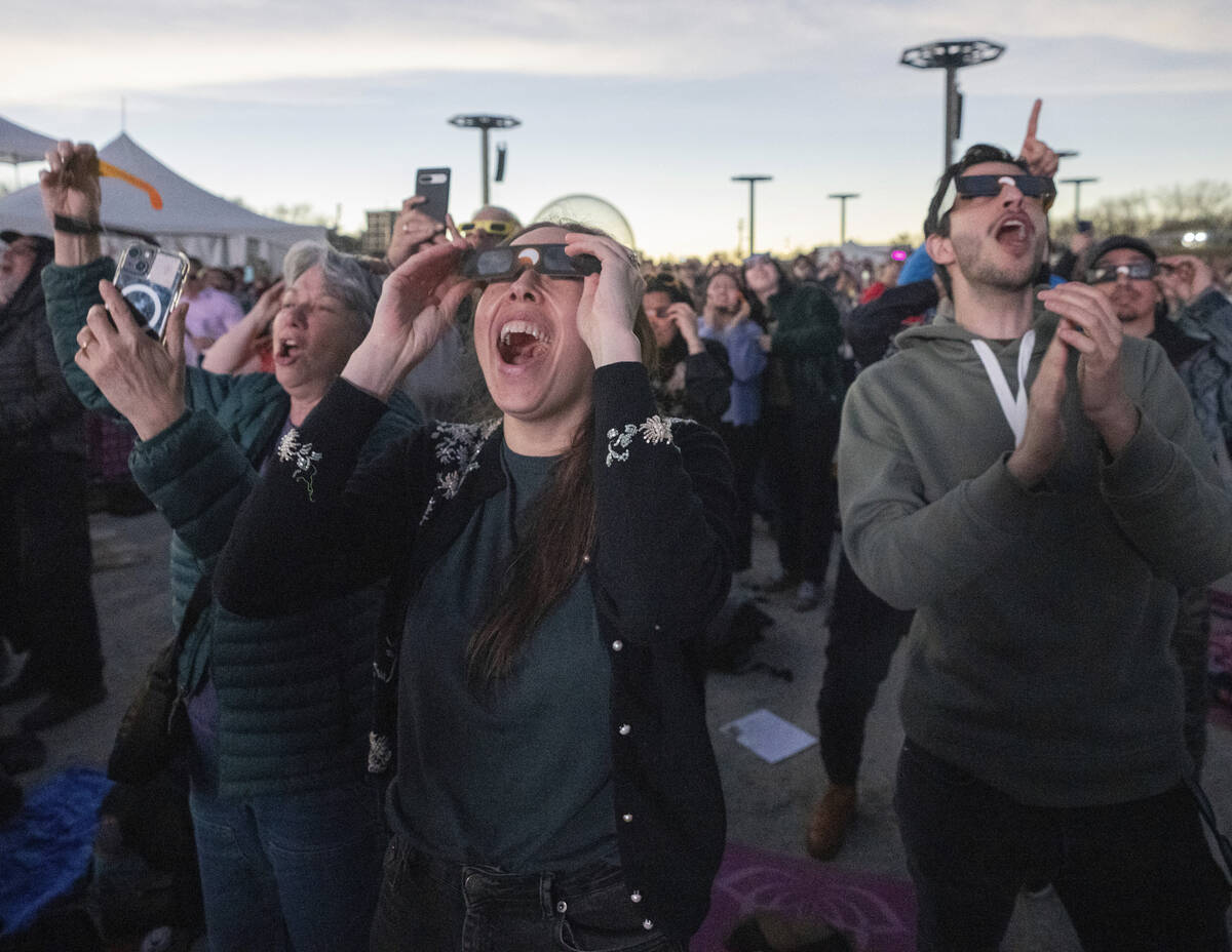 People react to totality occurring during the total solar eclipse at Parc Jean Drapeau, in Mont ...