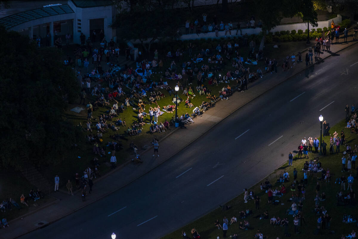 People watch from Dealey Plaza as the totality happens during the total solar eclipse viewed fr ...