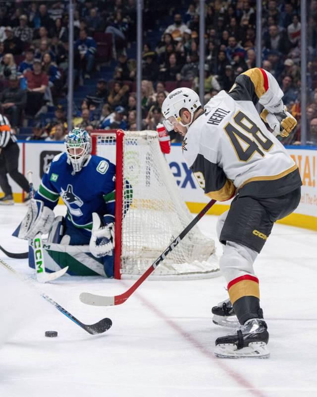 Vegas Golden Knights' Tomas Hertl (48) shoots the puck at Vancouver Canucks goaltender Arturs S ...