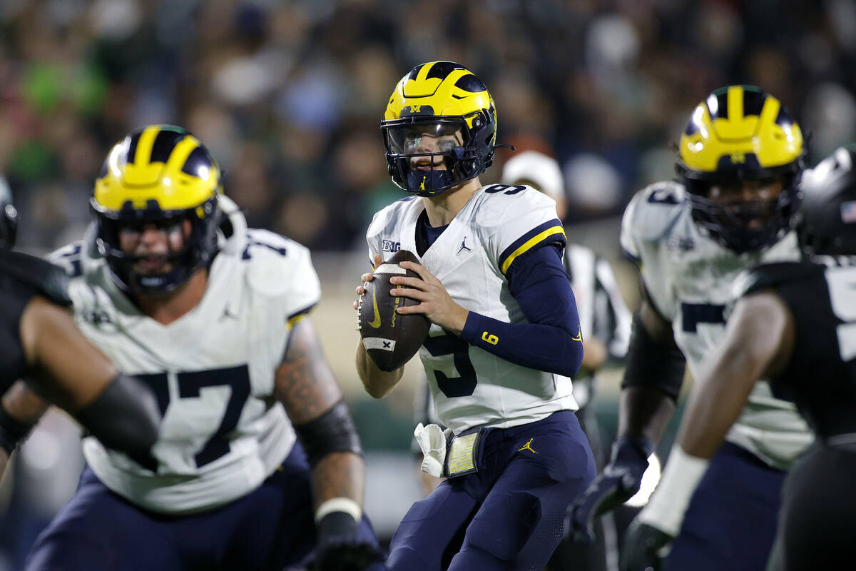 Michigan quarterback J.J. McCarthy (9) looks to throw during an NCAA college football game agai ...