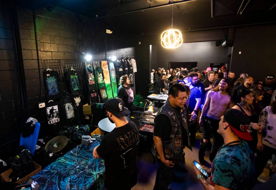 Attendees browse through band merchandise during a concert at the newly-opened venue Sinwave on ...