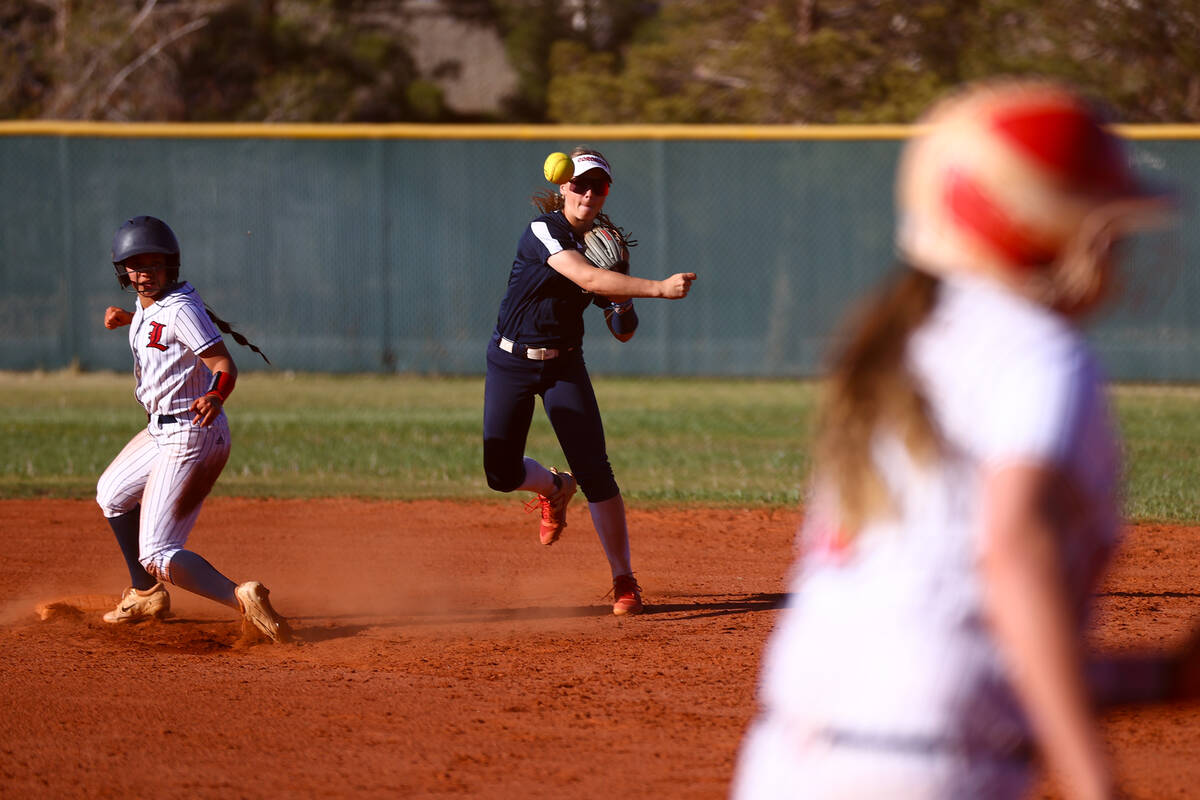 Coronado's Bailey Goldberg (1) throws to first base after outing Liberty's Ciana Cubi, left, du ...