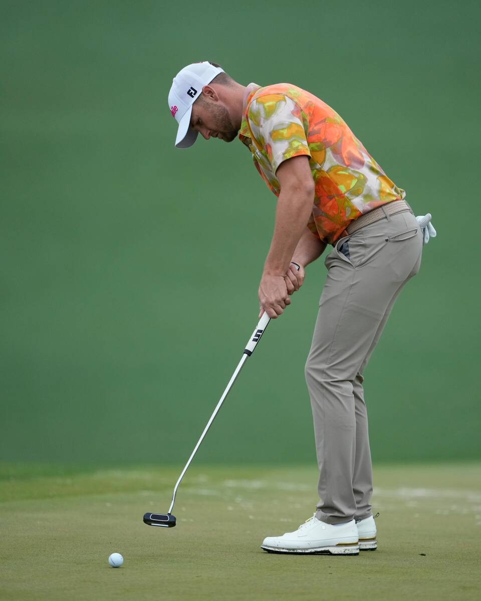 Wyndham Clark putts on the second green during a practice round in preparation for the Masters ...