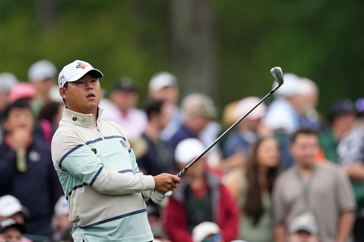 Si Woo Kim, of South Korea, hits on the 12th hole during a practice round in preparation for th ...
