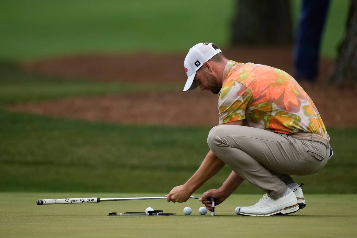 Wyndham Clark works on the practice green during a practice round in preparation for the Master ...