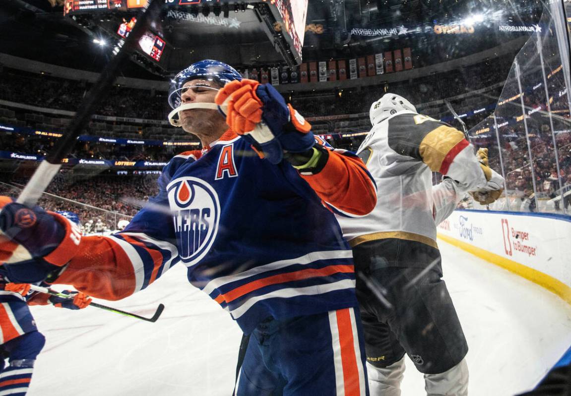 Vegas Golden Knights' Tomas Hertl (48) checks Edmonton Oilers' Darnell Nurse (25) during the th ...