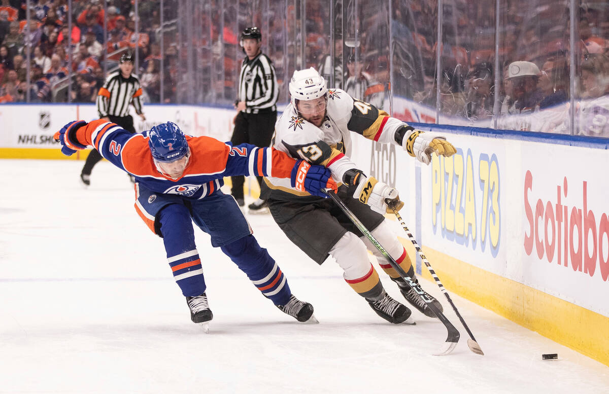 Vegas Golden Knights' Paul Cotter (43) Edmonton Oilers' Evan Bouchard (2) battle for the puck d ...