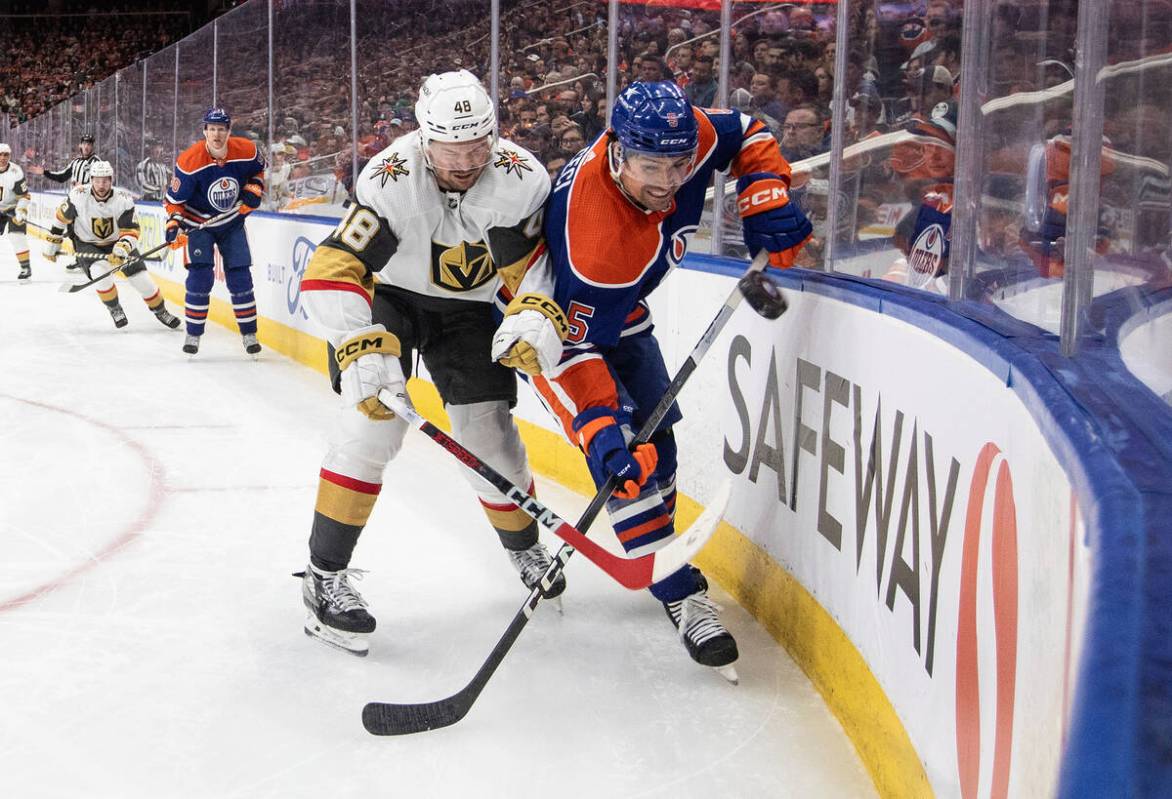 Vegas Golden Knights' Tomas Hertl (48) and Edmonton Oilers' Cody Ceci (5) battle for the puck d ...