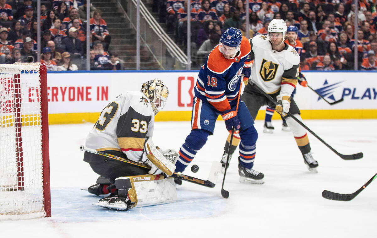 Vegas Golden Knights goalie Adin Hill (33) makes the save on Edmonton Oilers' Zach Hyman (18) d ...