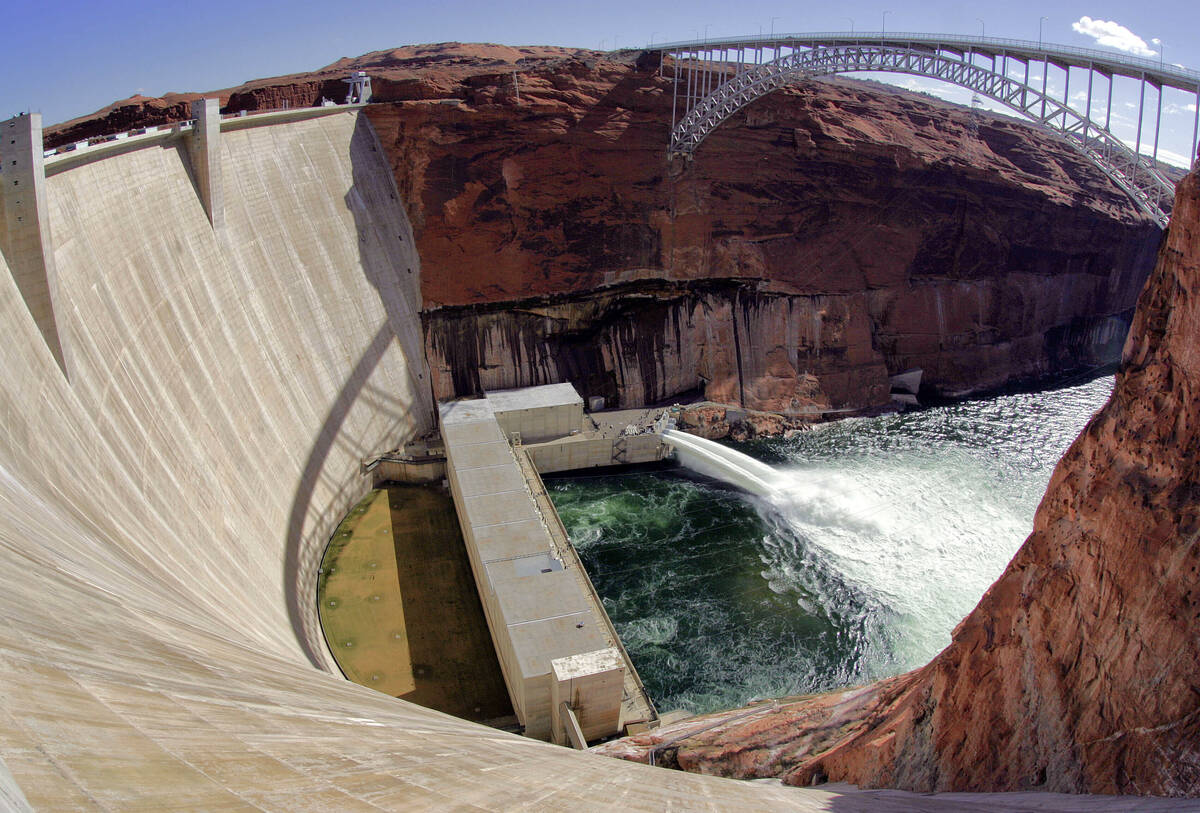 Water flows from the number one and two jet tubes as seen from atop the Glen Canyon Dam on Marc ...