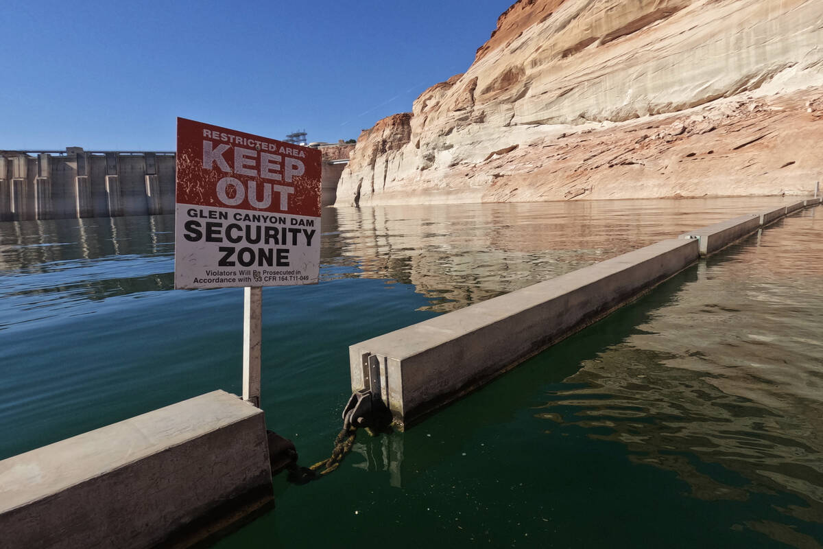 A sign reading "keep out" is displayed just upstream of Glen Canyon Dam at Lake Powell on June ...