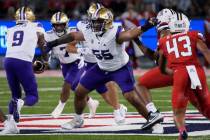 Washington offensive lineman Troy Fautanu (55) looks to block during the team's NCAA college fo ...