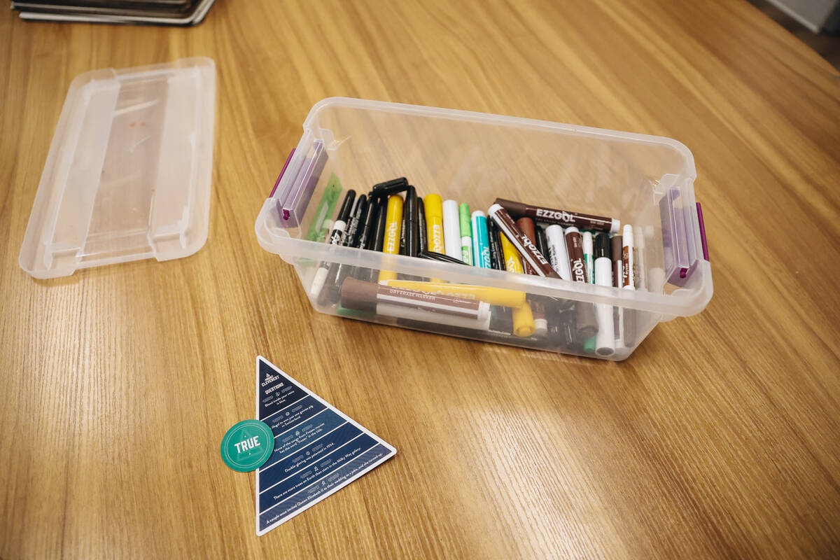 Markers and trivia questions are left on a table for a group activity at Inclusion Fusion on Fr ...