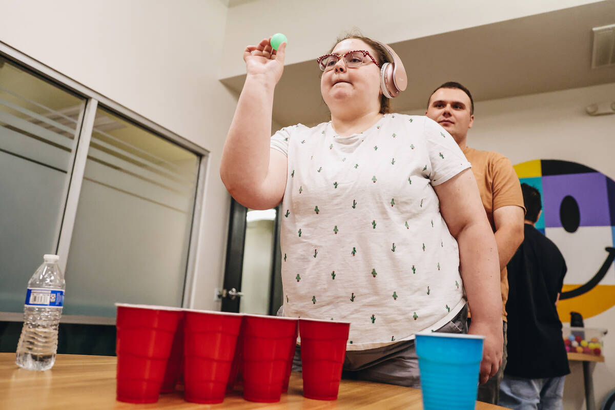 A social group partakes in a group activity of cup pong at Inclusion Fusion on Friday, April 19 ...