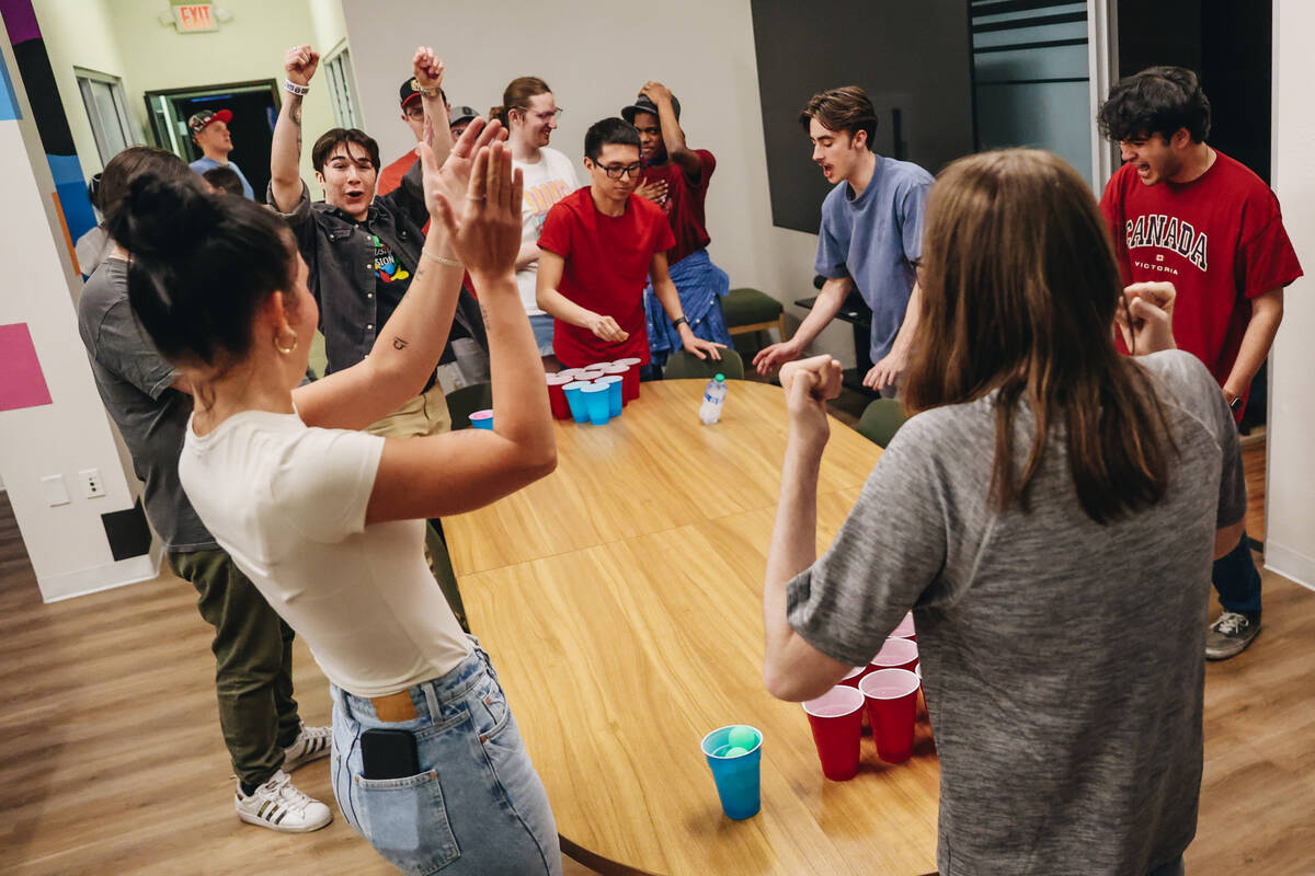 A social group partakes in a group activity of cup pong at Inclusion Fusion on Friday, April 19 ...