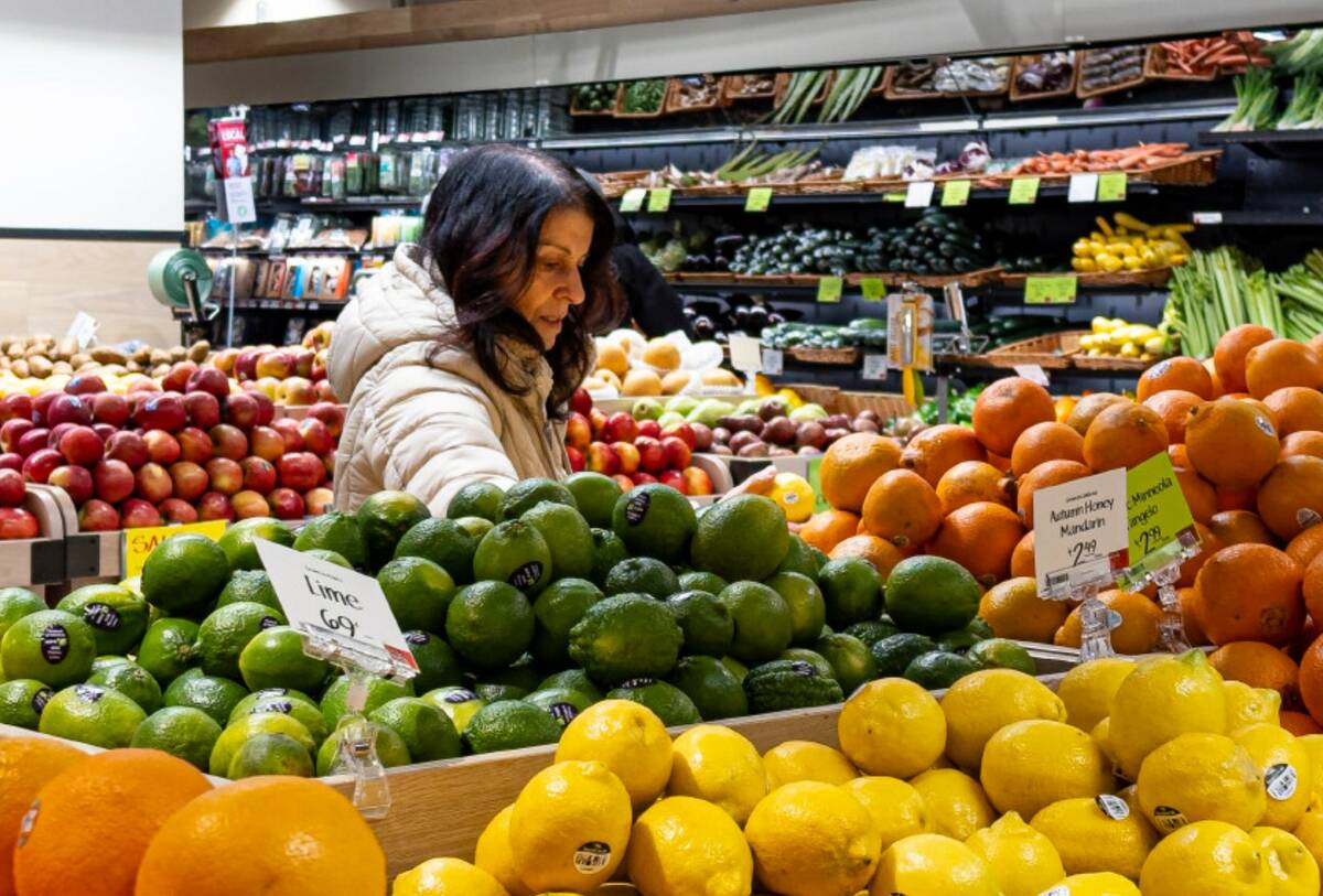 A woman browses produce for sale at a grocery store, Friday, Jan. 19, 2024, in New York. (AP Ph ...
