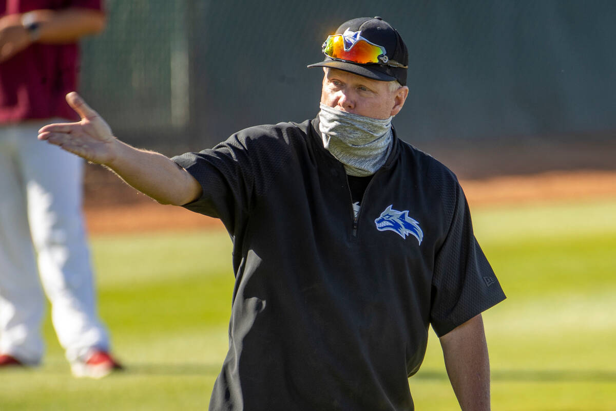 Basic High School head coach Scott Baker argues an out with the umpire versus Desert Oasis ...