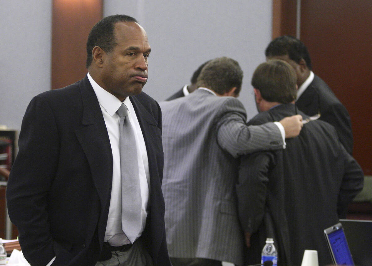 O.J. Simpson appears during his trial as co-defendant Clarence "C.J." Stewart confers ...