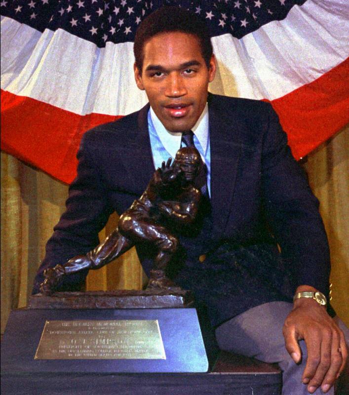 FILE - Southern Cal's O.J. Simpson poses with the Heisman Trophy at New York's Downtown Athleti ...