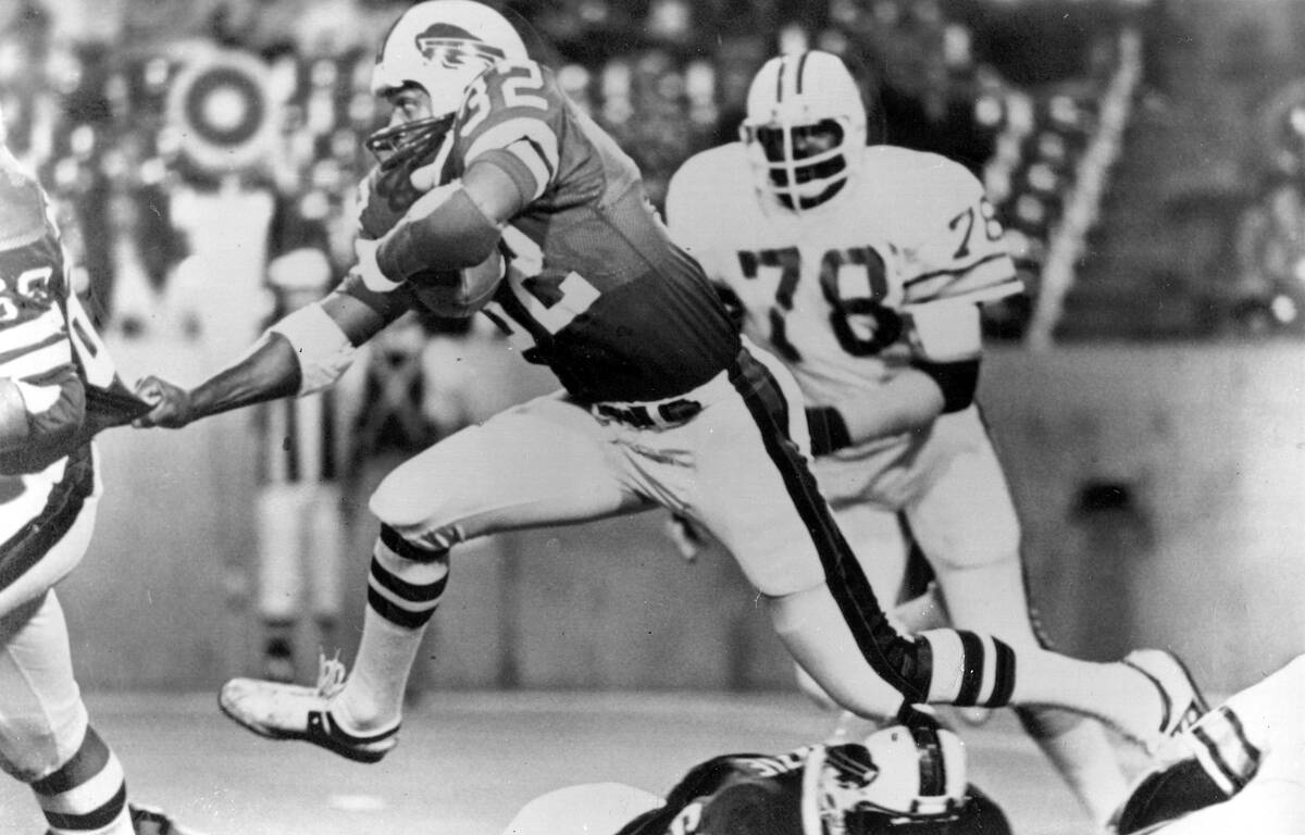 FILE - Buffalo Bills runningback O.J. Simpson (32) runs over some teammates as he latches onto ...