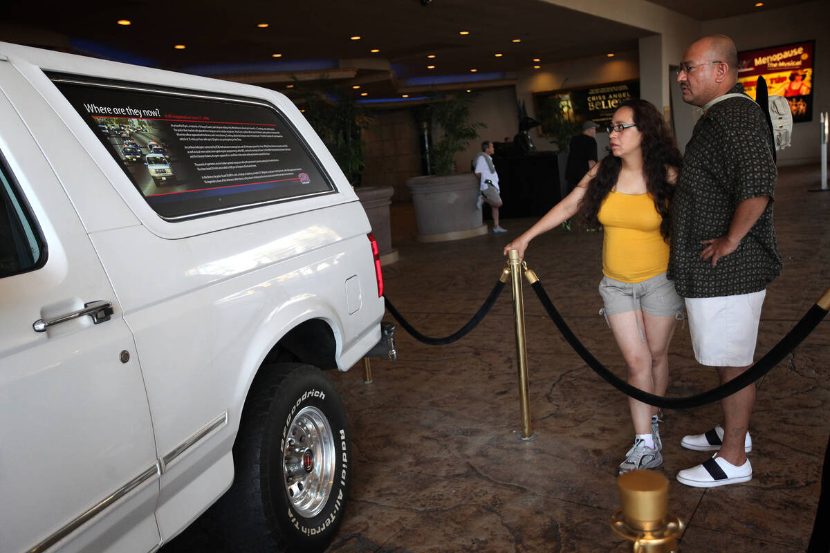 Maria Luna, left, and Aaron Ramos, both of San Jose, Calif., look over the Ford Bronco owned by ...