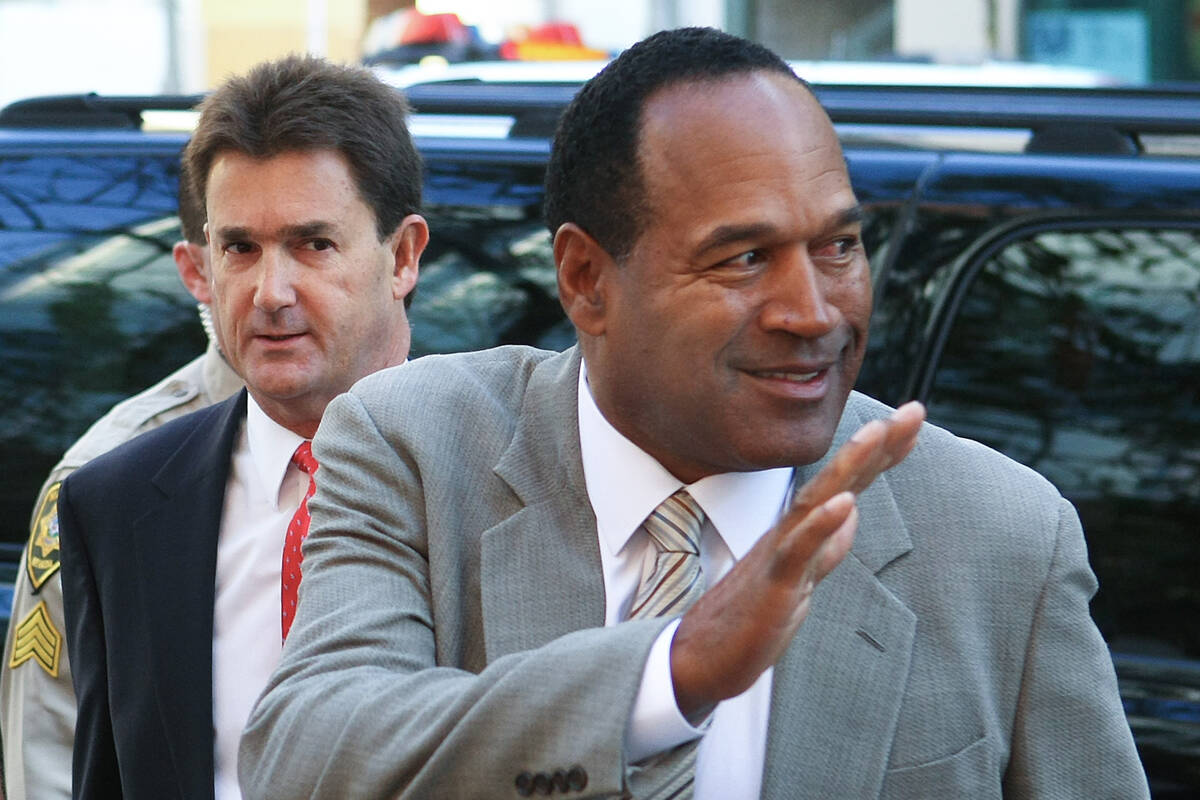 O.J. Simpson arrives with his attorney Yale Galanter, left, for the first day of Simpson's tria ...